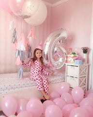 Mluchee number balloon used as a fun photo booth prop.