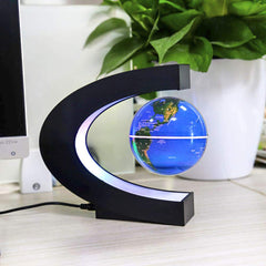 Floating globe by MOKOQI rotates slowly as a striking desk centerpiece.