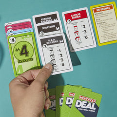 Monopoly Deal card game action cards illustrate theft, rent, and trade possibilities.