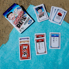 Monopoly Deal property cards and houses illustrating strategy