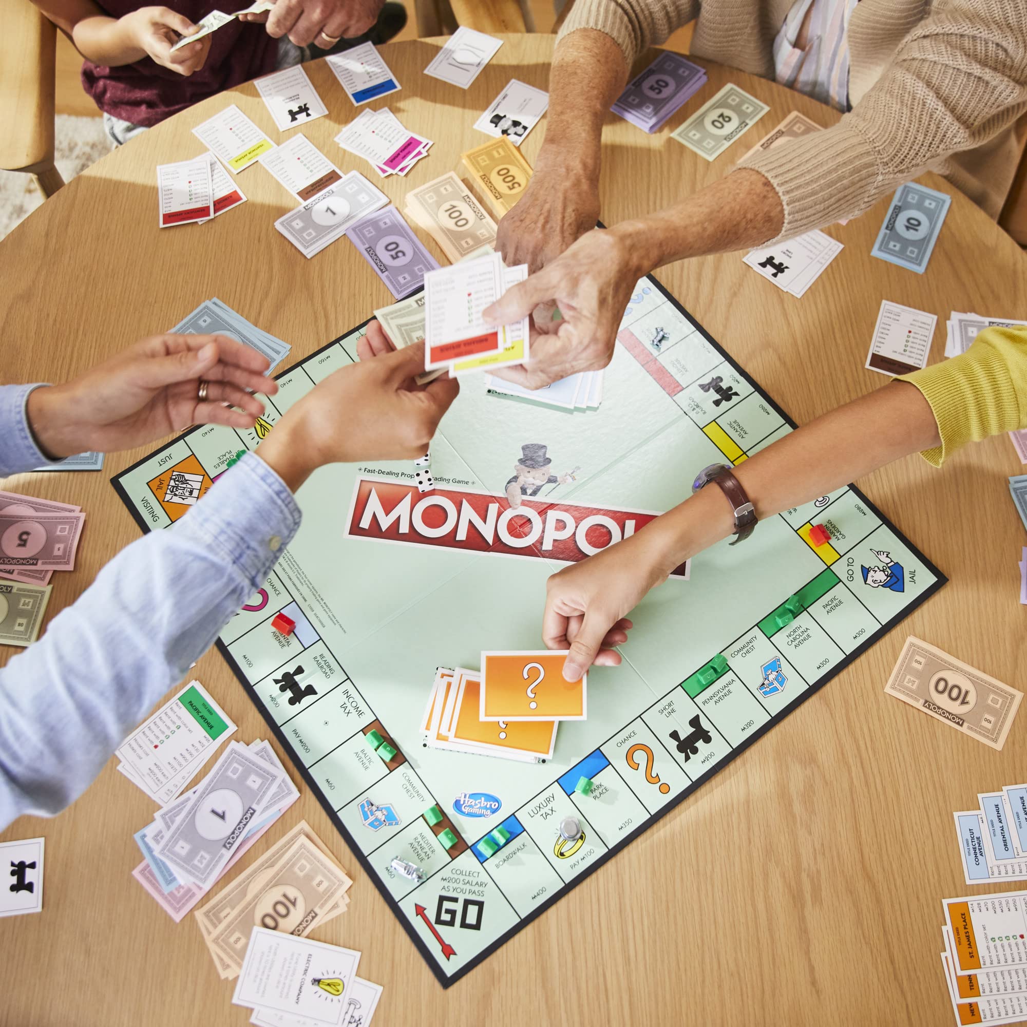 Monopoly money and properties spread shows value and negotiation opportunities