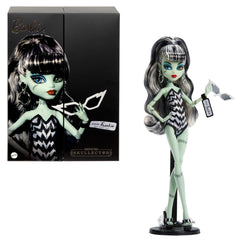 Monster High Frankie Stein doll in striped swimsuit for imaginative beach play.