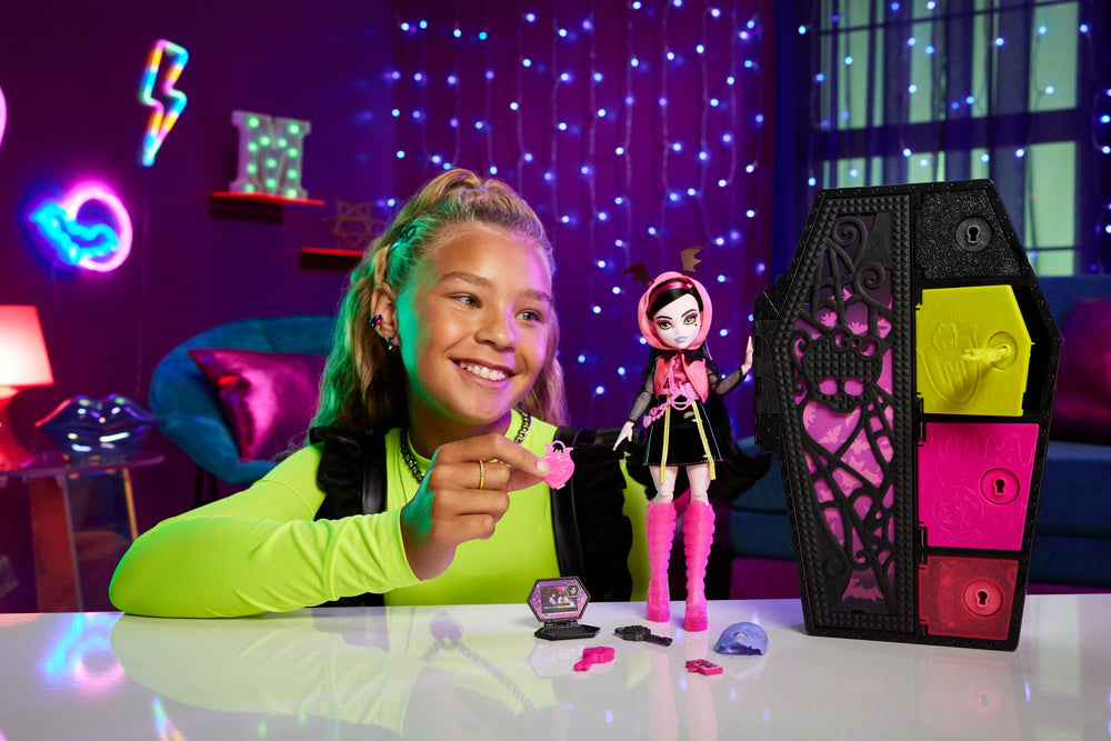Monster High Draculaura Color Reveal keys unlock four secret compartments for surprises.