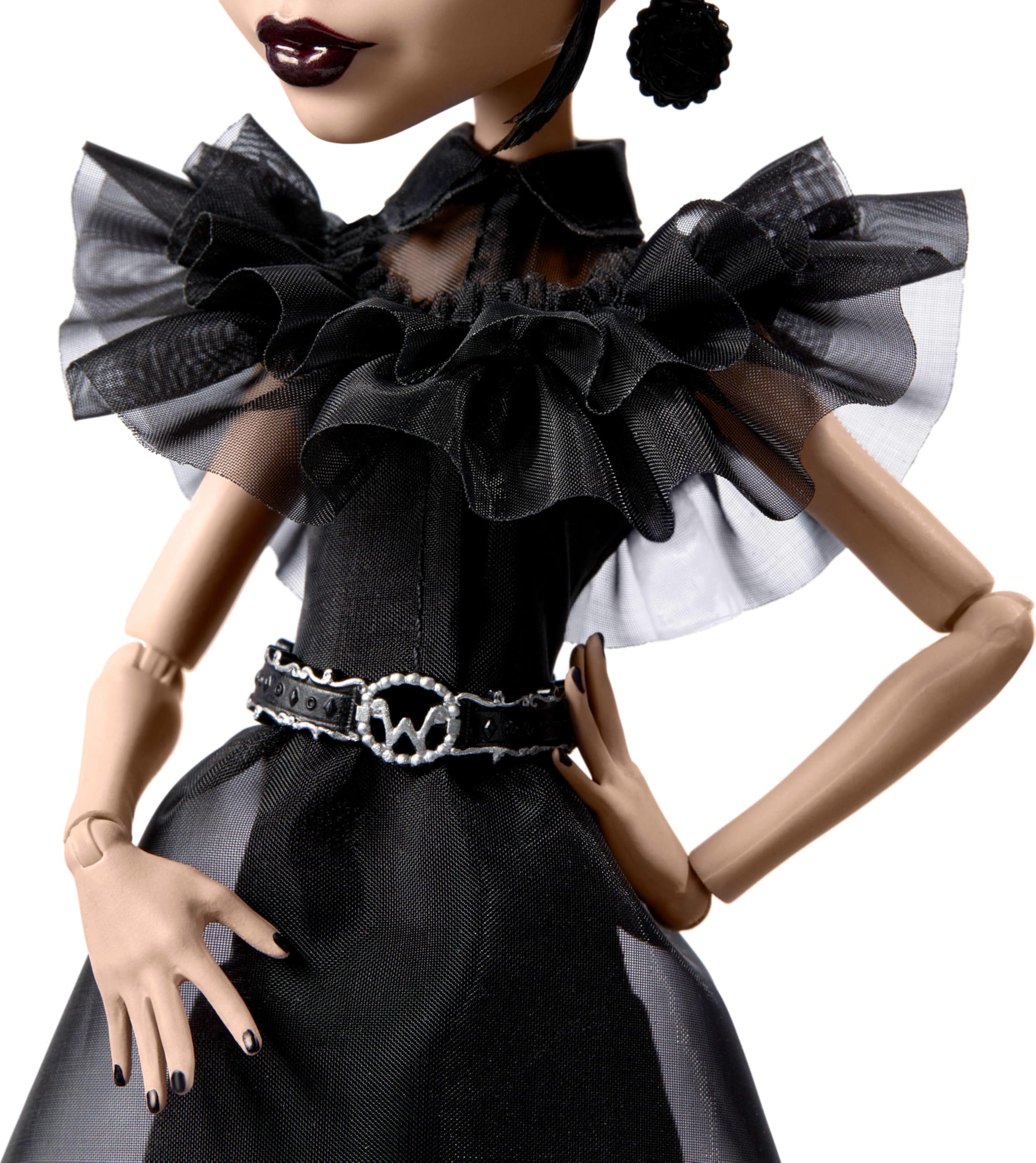 Monster High Wednesday doll showing belt and earrings for chic gothic styling.
