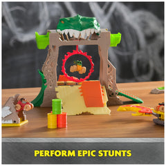 Kids performing front flips and ring-of-fire stunts on the playset.