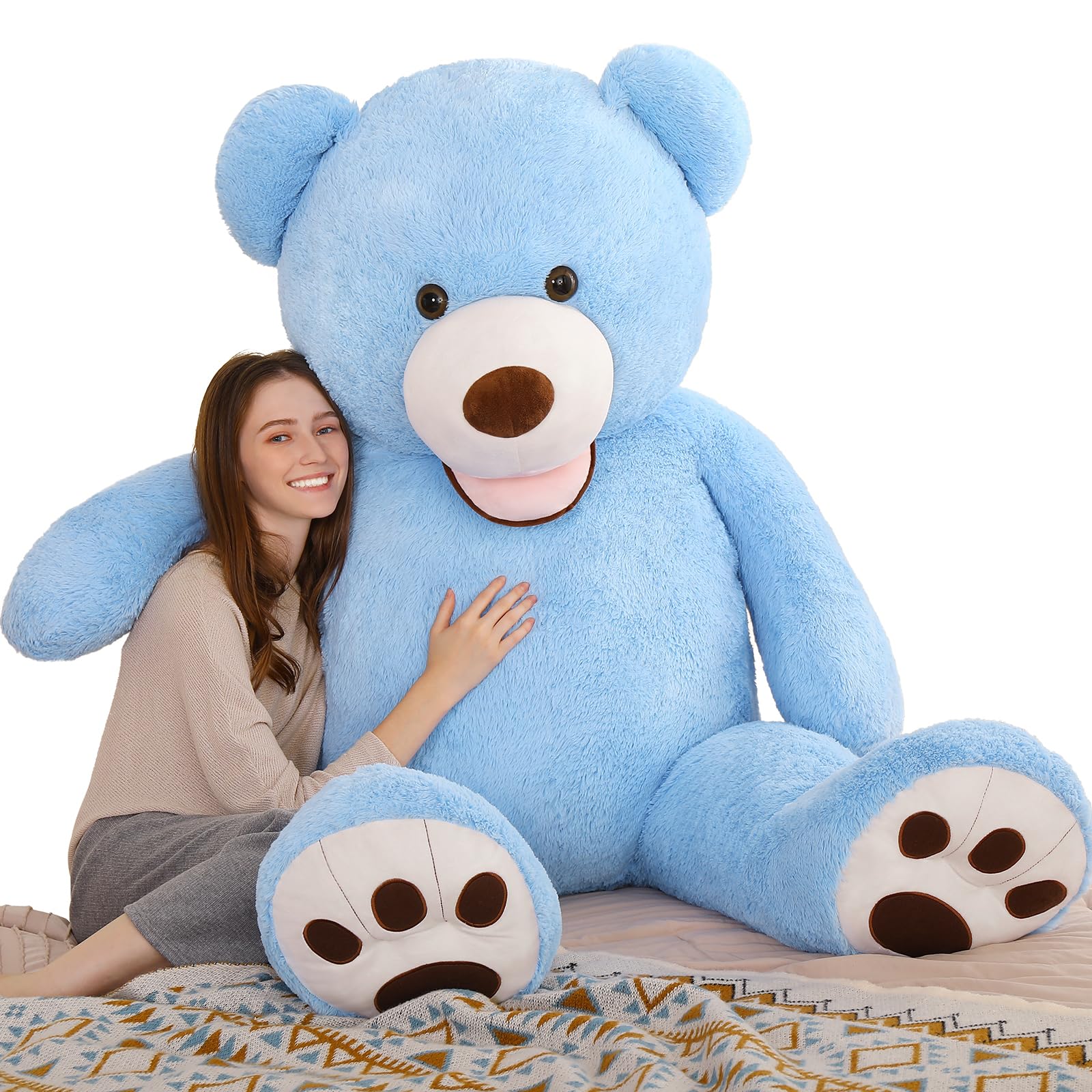 MorisMos giant blue 5ft teddy bear ready for a warm hug in a cozy bedroom
