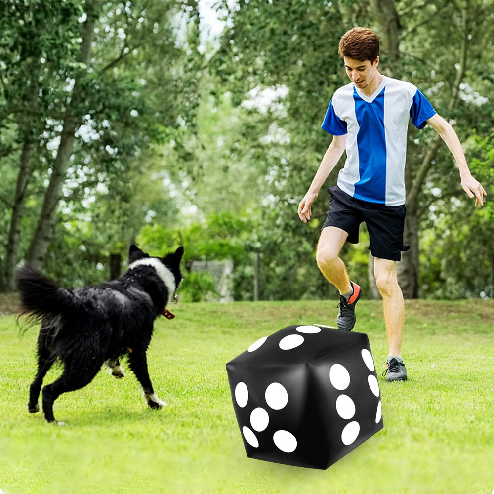 Mototo beach game scene featuring large inflatable dice for group play.