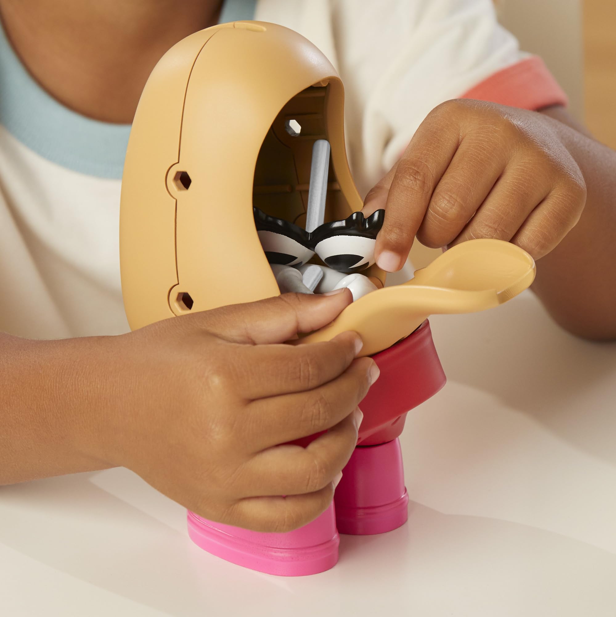Mr. Potato Head accessories like skirt, hair, and shoes for dress-up play.