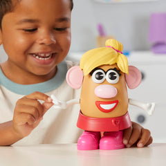Child mixes eyes, ears, nose, and mouth to create new Mr. Potato Head faces.
