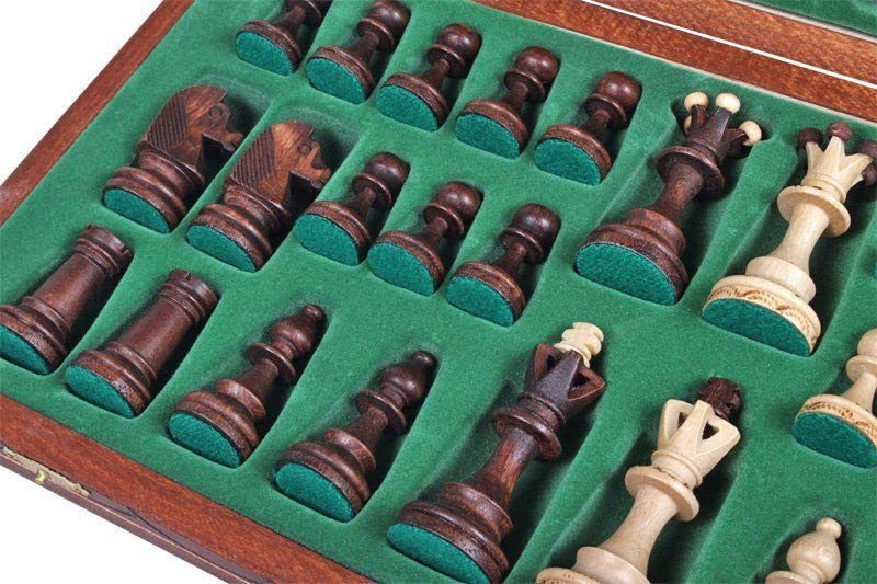 Folded chess board secured with brass clasps for travel and storage.
