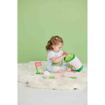 Mud Pie Pink Golf Plush Set rattle ball for sensory exploration during play.
