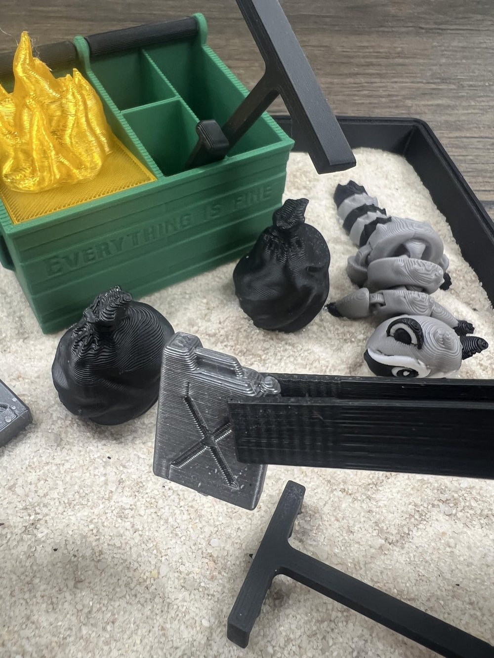MunnyGrubbers Dumpster Fire kit with miniature tools for creative arranging.