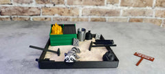 MunnyGrubbers Fidget-friendly garden with sand and mini tools.