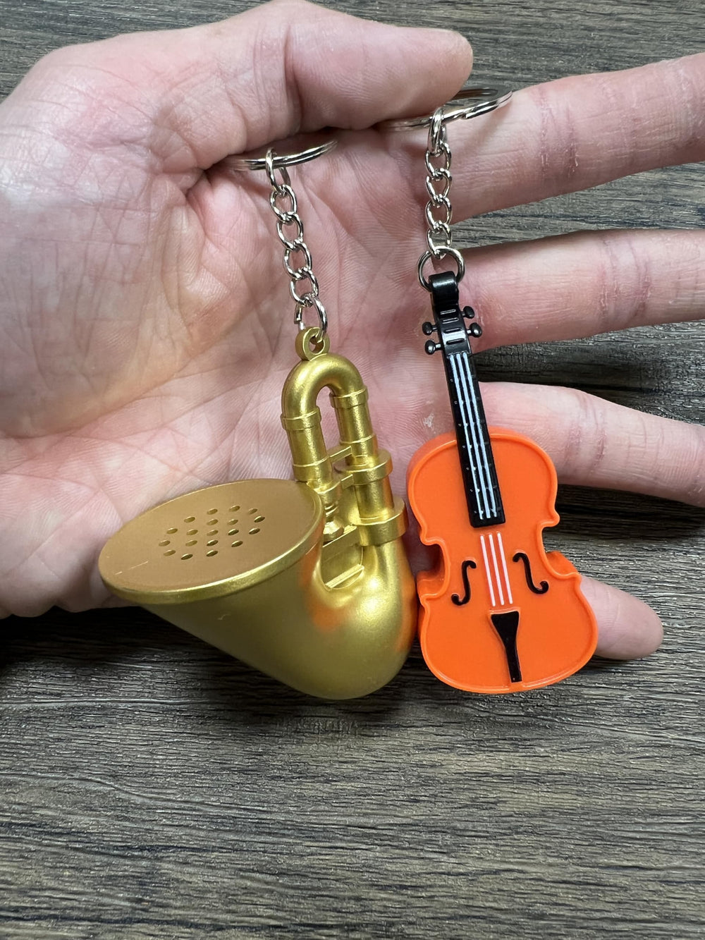 MunnyGrubbers trombone keychain on desk evokes humorous moments.