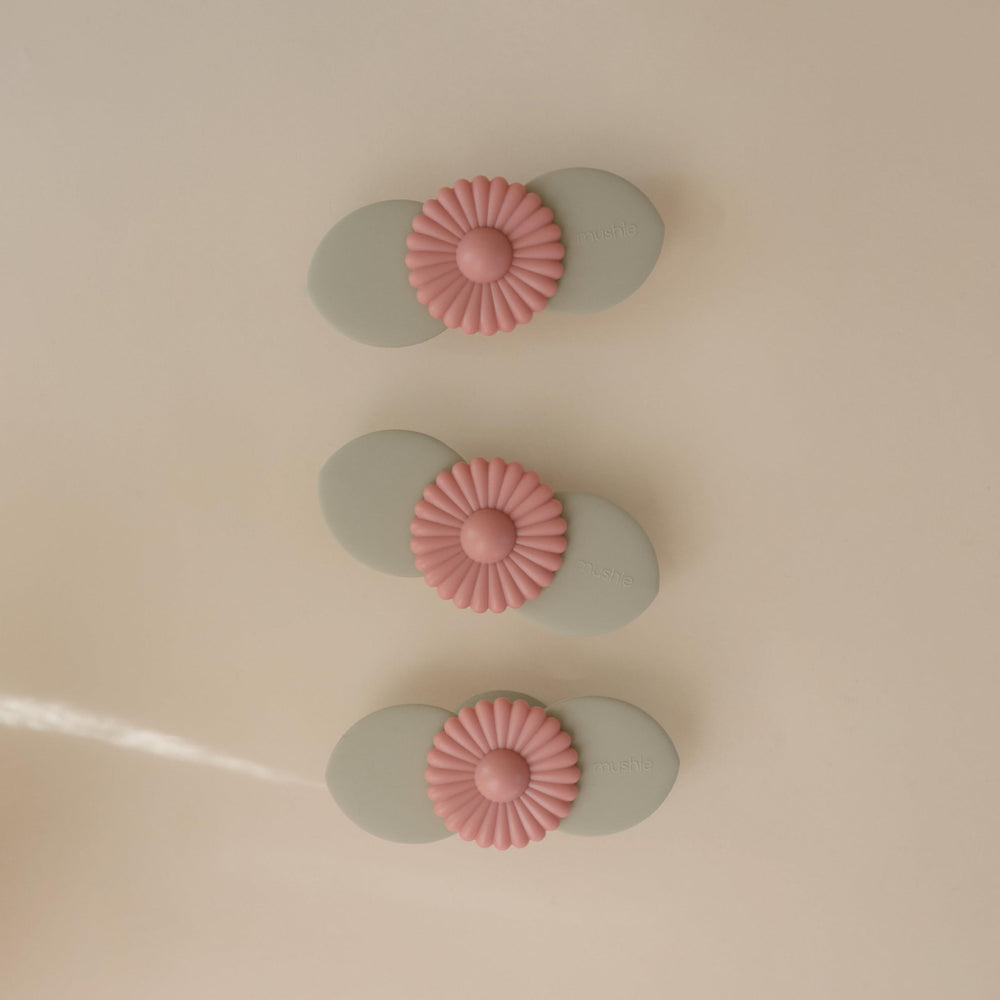 mushie Blossom suction spinner toy attached to highchair for focused toddler play