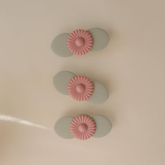 mushie Blossom suction spinner toy attached to highchair for focused toddler play