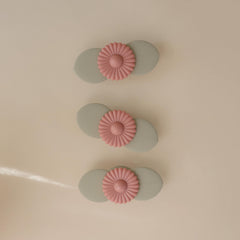 mushie Blossom suction spinner toy attached to highchair for focused toddler play