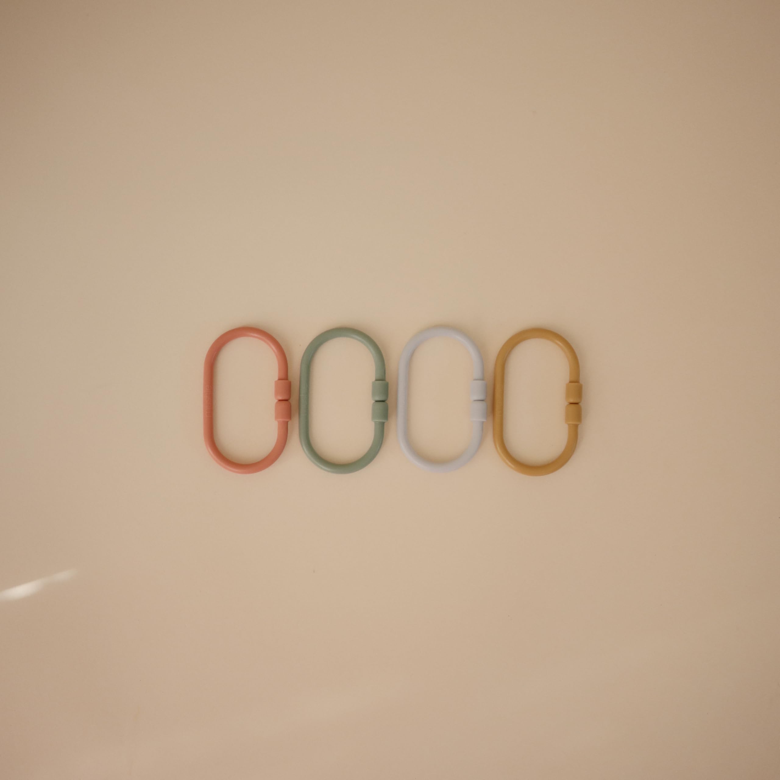 Mushie Chain Link Rings attach to car seats for on-the-go entertainment.