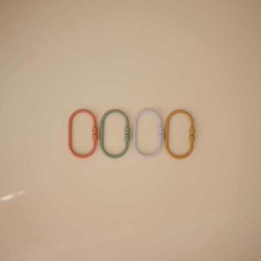 Mushie Chain Link Rings attach to car seats for on-the-go entertainment.