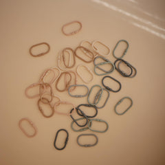 Mushie Chain Link Rings in stone color for reaching and sorting activities
