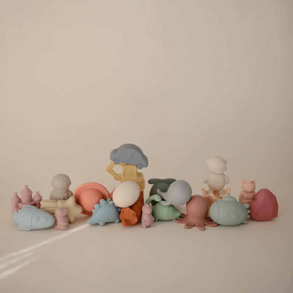 Mushie Dino Bath Toy opens into two pieces for easy cleaning