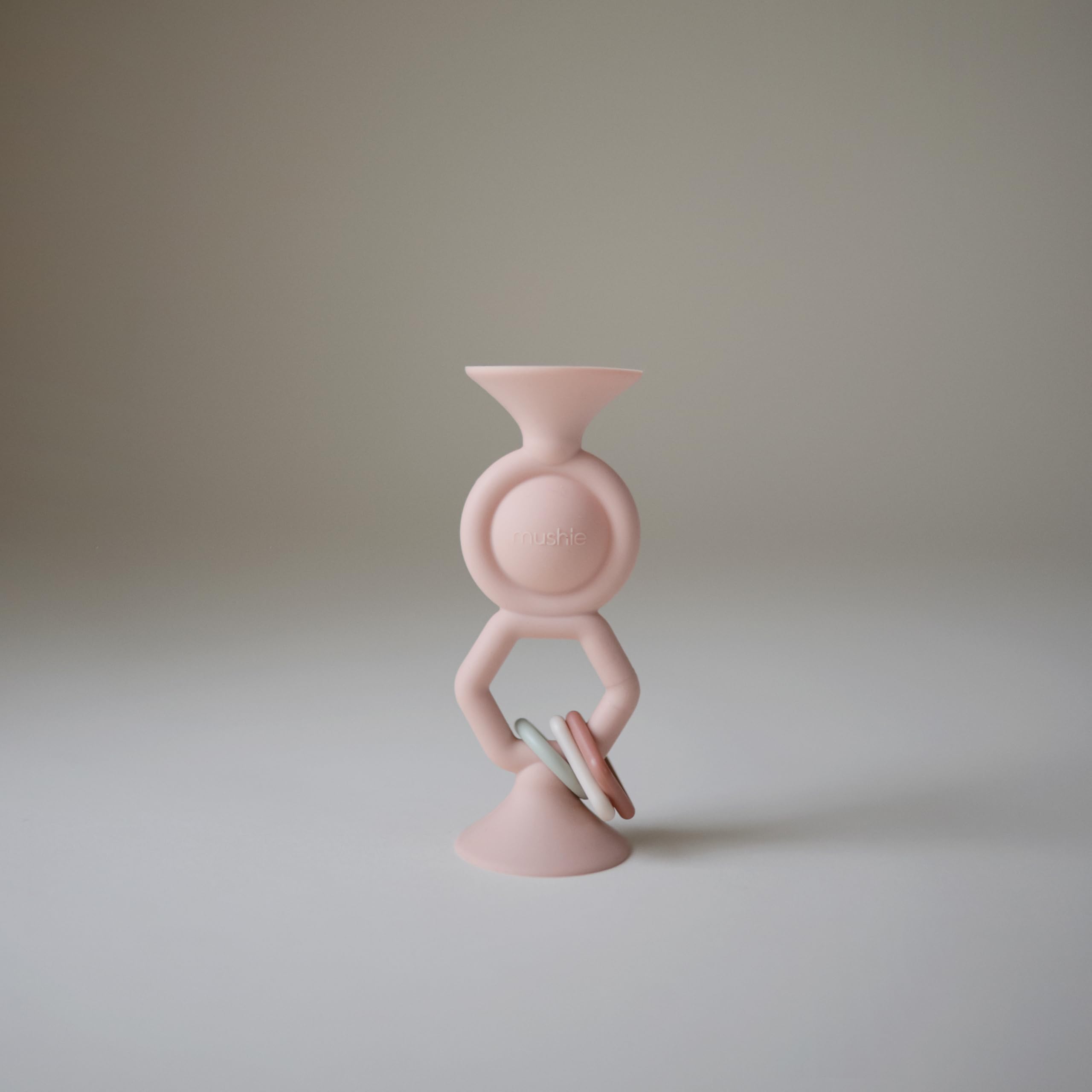 Mushie HexaPop suction toy bottom cups grip a table for steady play