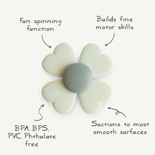 Mushie Lucky Suction Spinner Toy on a high chair promotes independent play.