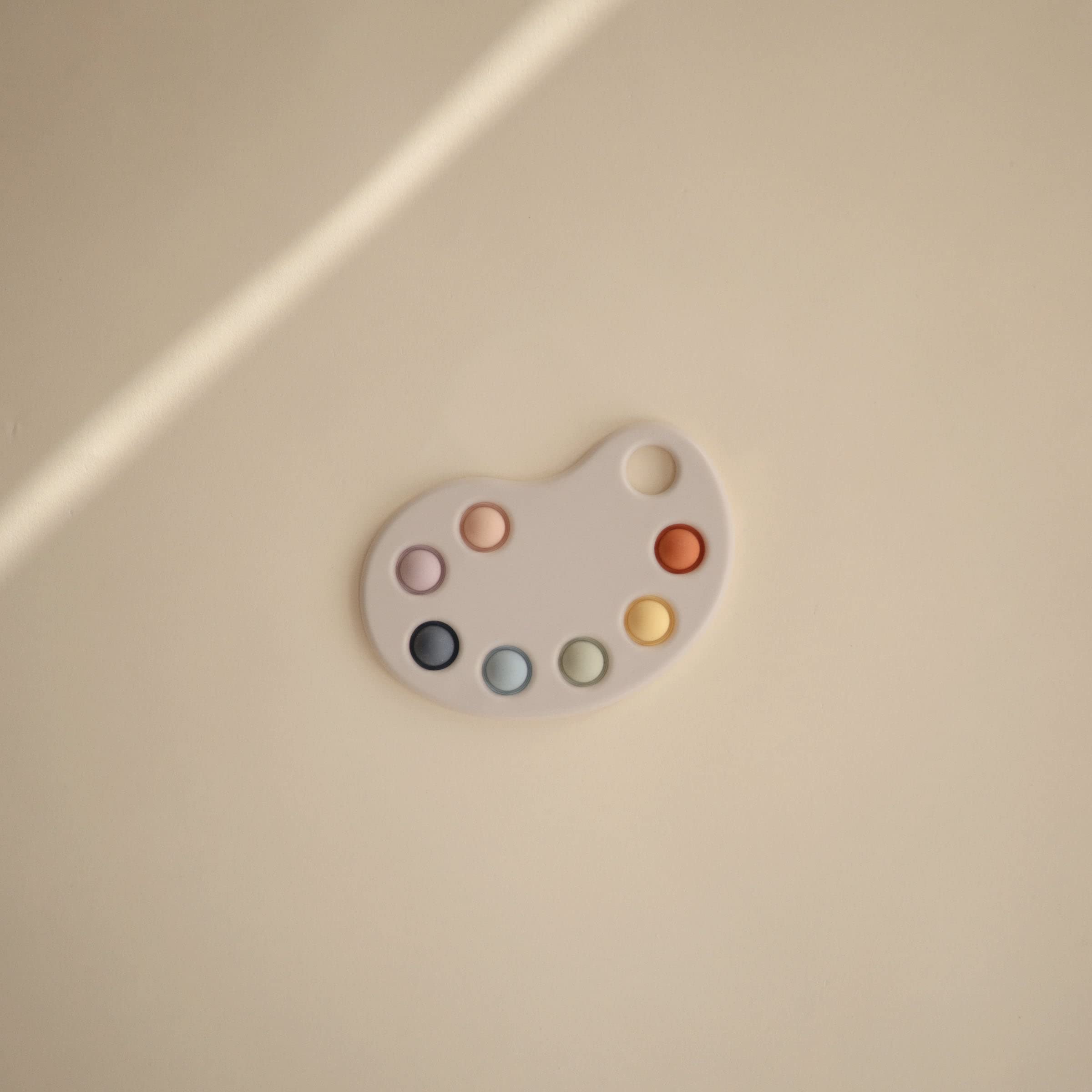 Mushie Paint Palette Press Toy bubbles close-up highlights gentle pop for focus