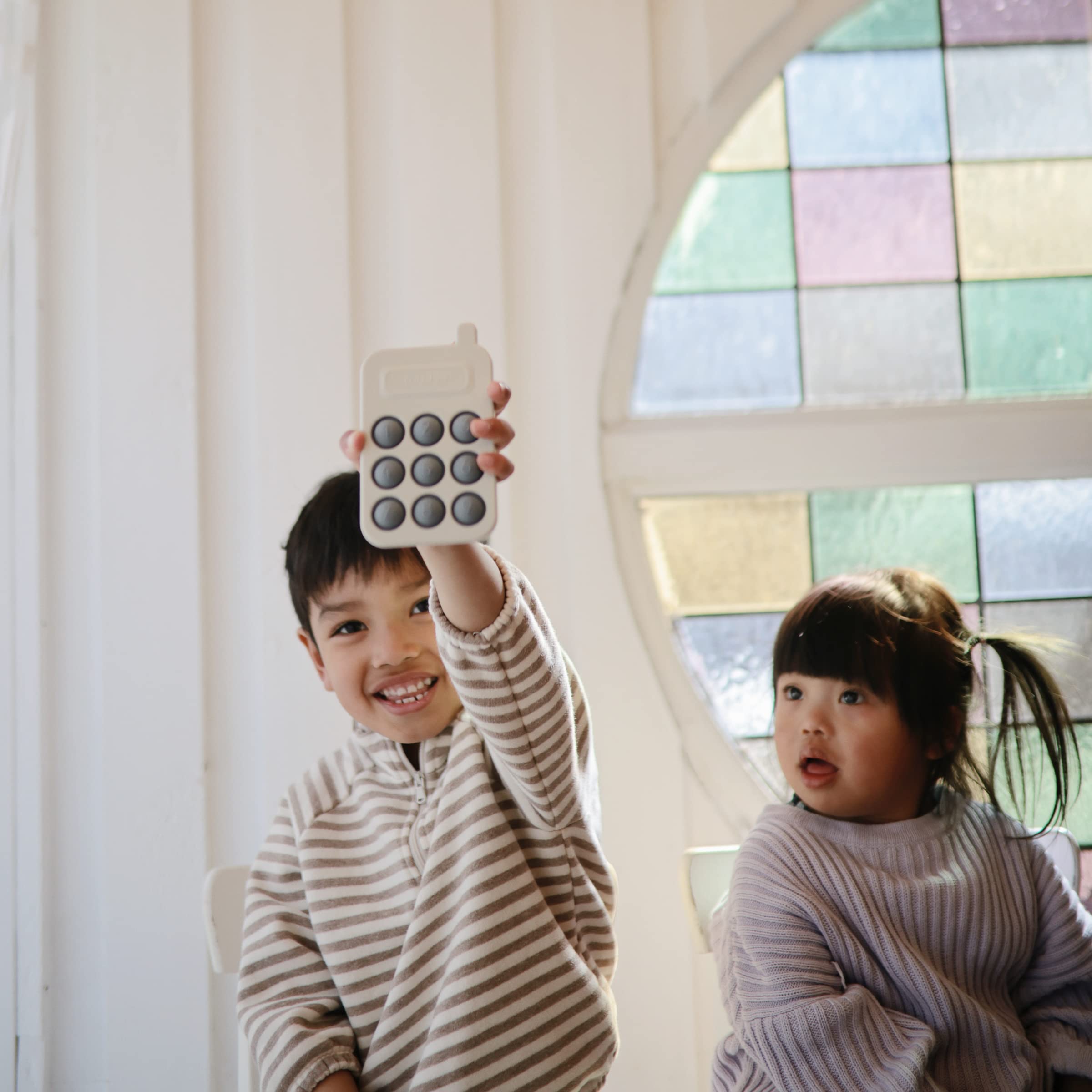 Mushie Phone Press Toy Tradewinds, closeup bubbles, tactile feedback that engages curious hands