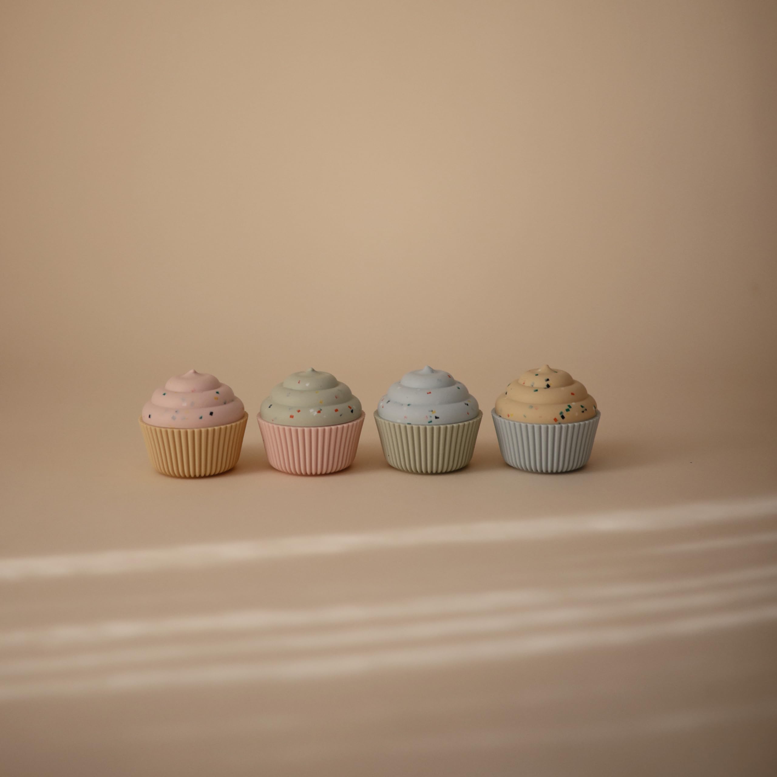 Mushie cupcake toy 4-pack with soft textures for soothing exploration.