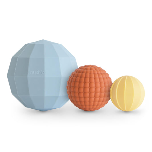 Mushie silicone nesting spheres powder blue pack 3 hero shows tactile play and stacking