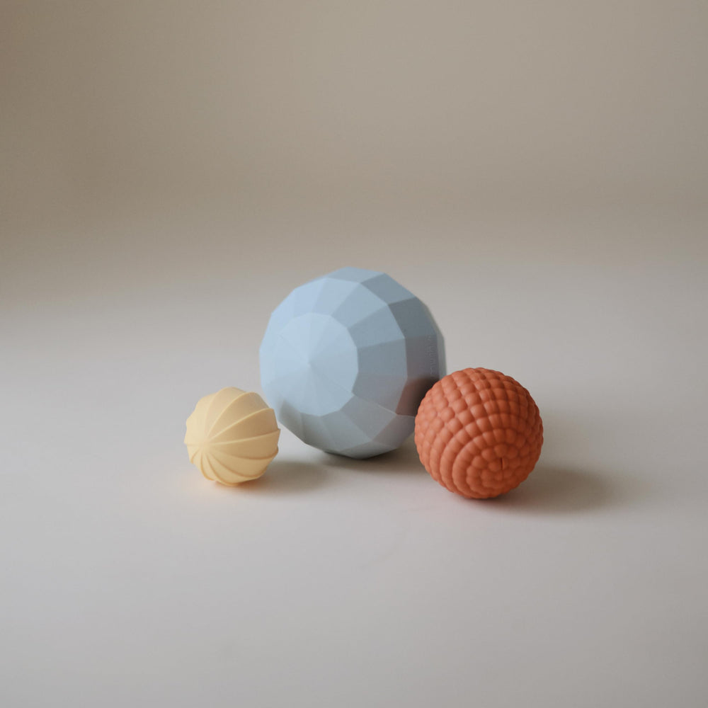 Mushie silicone nesting spheres powder blue stacking demo highlights spatial awareness