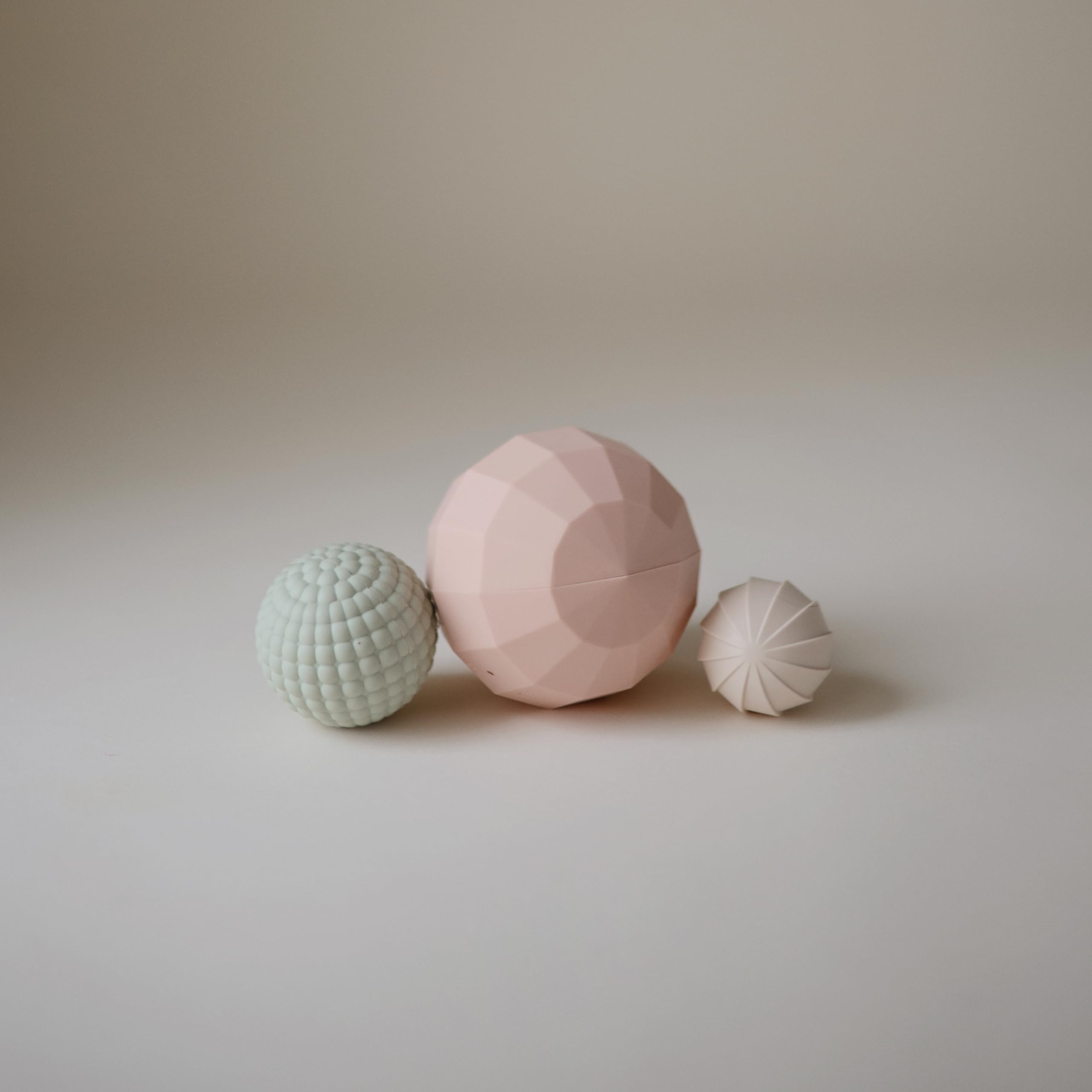 Mushie silicone spheres blush pack-3 promotes gentle stacking and sorting.