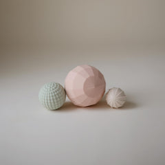 Mushie silicone spheres blush pack-3 promotes gentle stacking and sorting.
