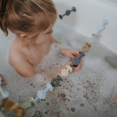 Mushie silicone suction builder daisy soft texture enhances grip for little hands.