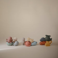 Mushie Space Bath Toy set enhances imaginative bath play for toddlers.