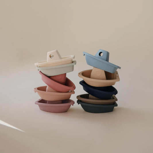 Mushie Stackable Bath Boats Ocean-2, forming a floating train across the tub