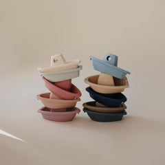 Mushie Stackable Bath Boats Ocean-2, forming a floating train across the tub