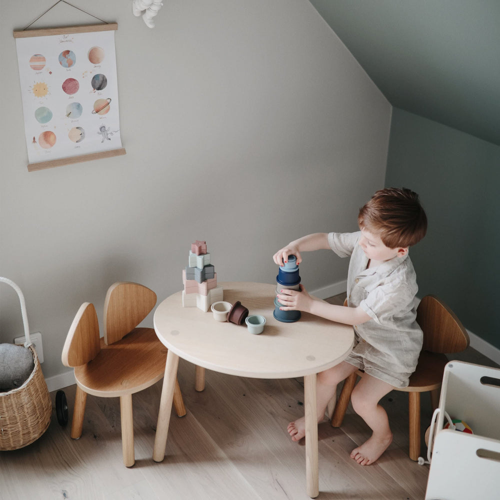 Mushie forest stacking cups during bath time for gentle sensory exploration.