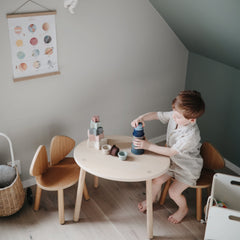 Mushie forest stacking cups during bath time for gentle sensory exploration.
