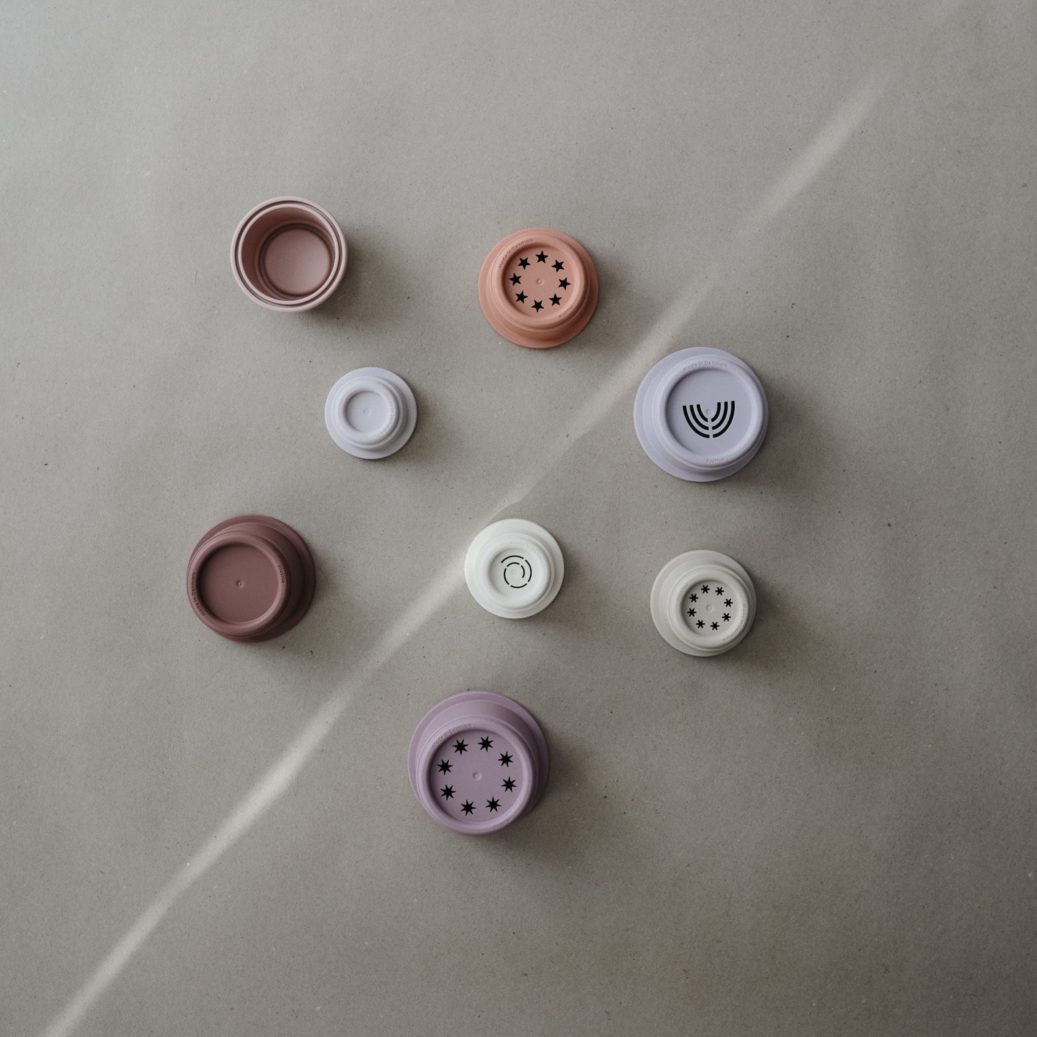 Mushie Stacking Cups Petal in baby's hands supports grasp development during early play.