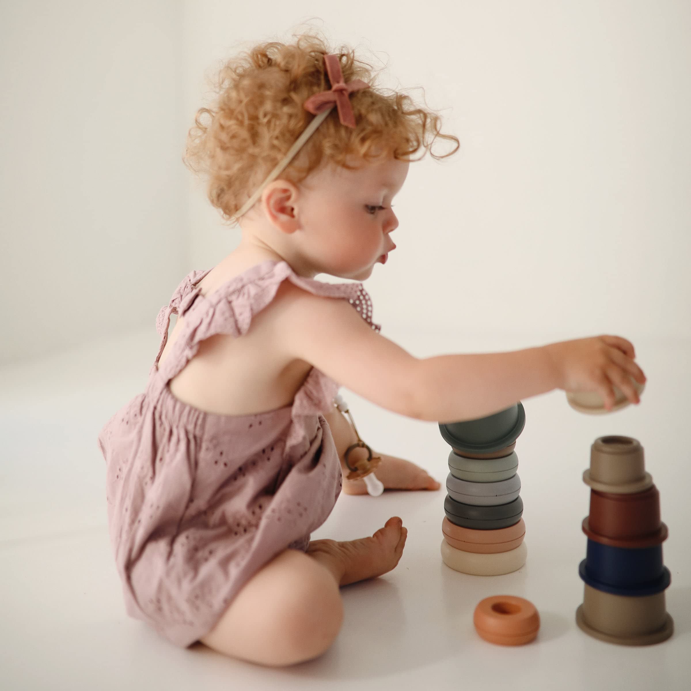 Stacking fosters hand-eye coordination and problem-solving through guided play.