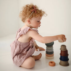 Stacking fosters hand-eye coordination and problem-solving through guided play.