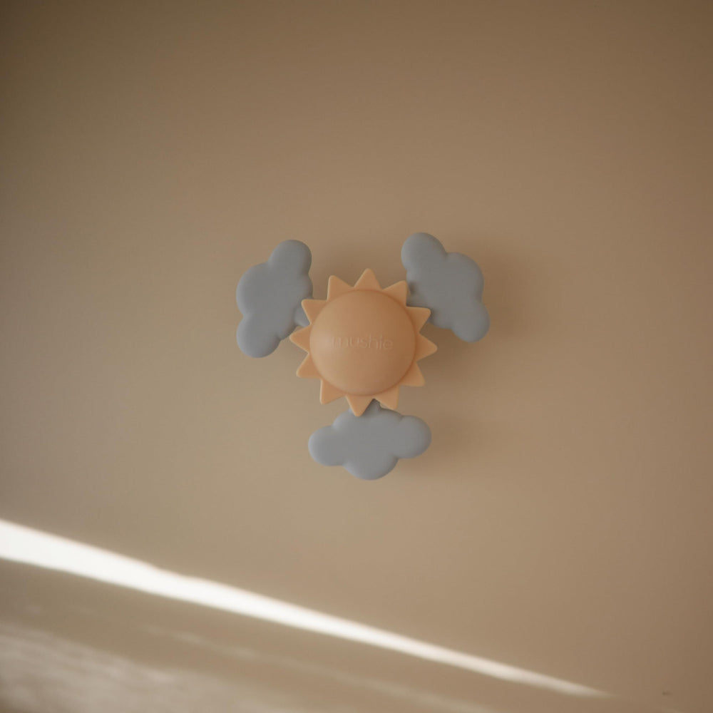 Mushie Sunshine soft silicone clouds spinning for tactile exploration