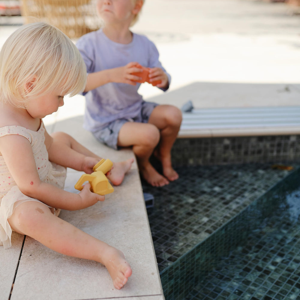 Mushie Vehicles bath toy truck open-pieces, sanitize easily after bath adventures.
