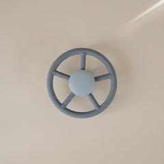Mushie Wheel leaves spin around a dinosaur center for visual focus.