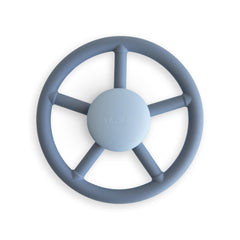 Mushie Wheel suction spinner toy on bath surface for sensory play.