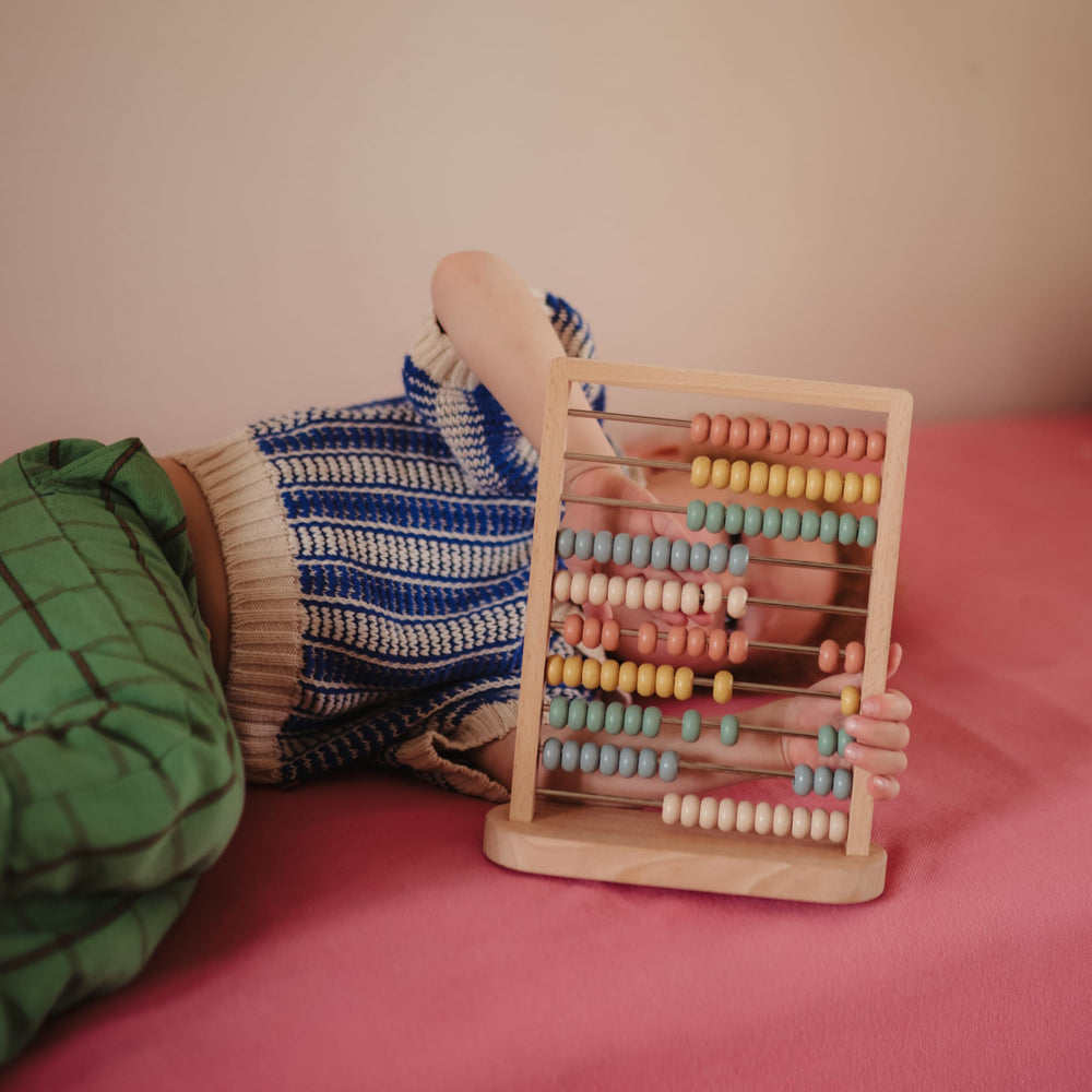 Mushie wooden abacus Montessori toy encouraging hands-on discovery