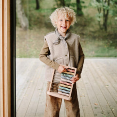 Mushie wooden abacus in a nursery setting to inspire timeless play