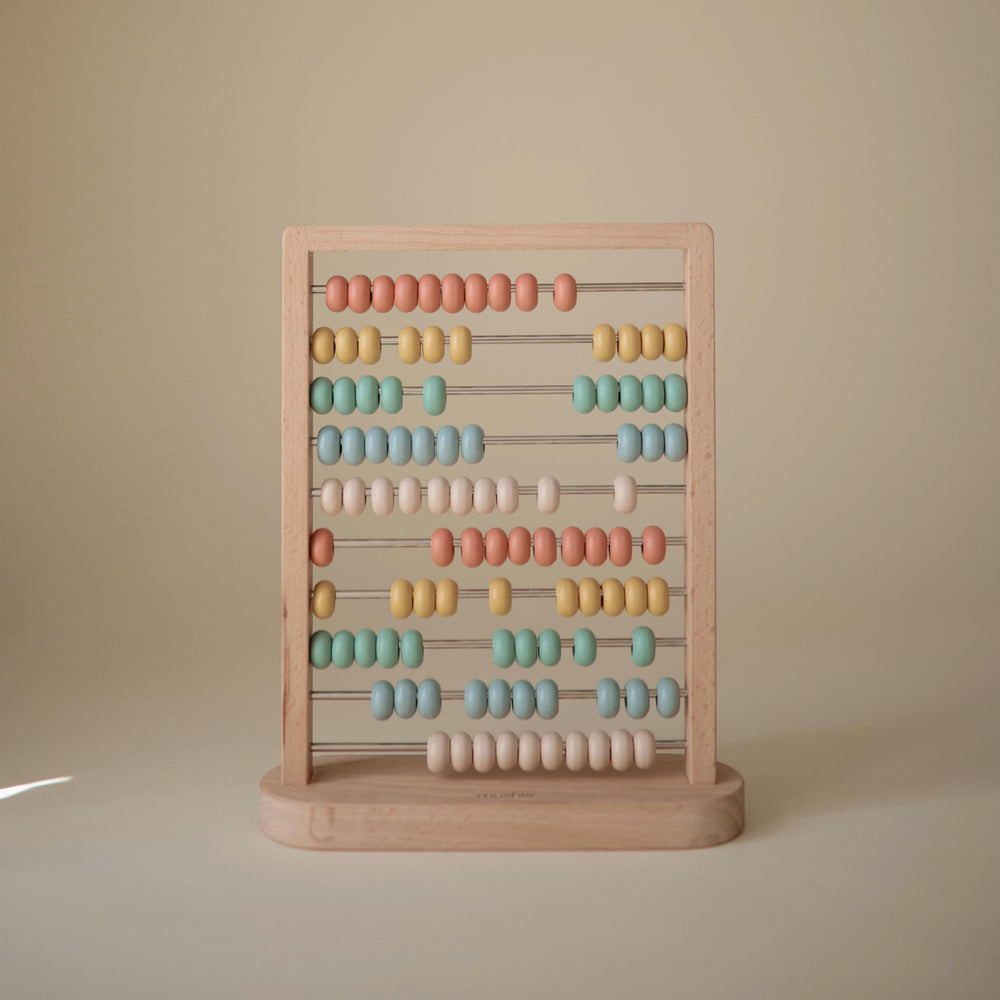 Mushie wooden abacus rails with colorful beads for fine motor play